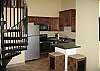New kitchen cabinetry, appliances and granite counter tops.  View of sprial staircase to loft.