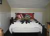 Queen size bed, ceiling fan, 19" flat screen TV.  Bath with shower off bedroom.  Open to the living room area.