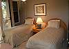 Downstairs bedroom - twin beds. Ceiling fan and window a/c.