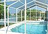 Central Gulf Coast House rental - Interior Photo - A view of our pool and patio area with views of the lake