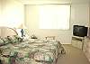 Siesta Key Condominium rental - Interior Photo - Master bedroom featuring a large king sized bed and a tv set