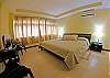 Spacious master bedroom with cozy king size bed