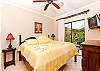 A spacious master bedroom with a comfortable king size bed