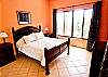 A nice spacious master bedroom with a queen size bed
