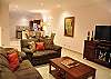 Spacious living area with nice middle table, cozy sofas and LCD TV
