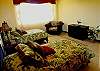 A nice bedroom with 2 twin size beds and a cozy sofa