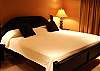 A comfortable master bedroom with a king size bed