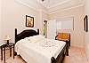 A spacious bedroom with cozy king size bed