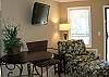 Living area has a nice flat screen tv w/two chair barista for indoor dining...