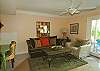 Tastefully decorated living room w/a sliding glass door that opens up to a private back courtyard. The pool is just steps from the back gate.