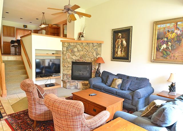 The cozy living room is large enough for the entire party to get together! It has a fireplace, a sofa sleeper, and a TV. 