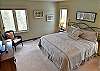 Spacious master bedroom, with a king-sized bed, stunning views, and a newly remodeled, private bathroom. 