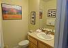 The main level bathroom is a half bath and sits right next to the fully-equipped kitchen. 
