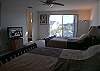 Upper level guest bedroom with two queen beds and flatscreen cable TV.