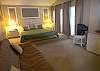 Master bedroom with king size bed, double futon and cable TV/DVD/VHS.
