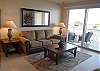 Living room with new queen size sofabed & sliding glass doors to the balcony.