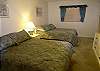 Second bedroom with two double beds and an adjoining bath.