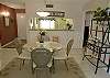 Dining area with seating for four and a pass-thru to the kitchen.