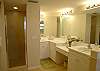 Master bath with double vanities, tile shower.