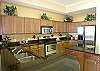Granite countertops and stainless steel appliances in the spacious kitchen.