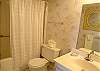 Bathroom with tub/shower and washer/dryer.
