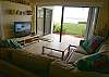 Living area with flatscreen TV/DVD and sliding doors to the bay & beach.