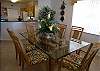 The dining room table seats six. The windows look out towards the beach.