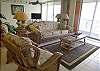 This tropical living room has a sleeper sofa, new flatscreen TV/DVR and sliding glass doors to the balcony.