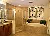 Master bath with spa tub, walk-in shower and separate vanities.