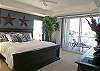 Master Bedroom with king size bed and sliding glass doors to the bayfront balcony.
