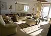 Creamy leather sofa, loveseat and chair, along with ceiling fans, skylights, a 27" tv and dvd player and a Gulf front balcony.