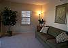 Den with queen size sofabed and private balcony.