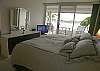 Master bedroom with sliding glass doors to the bayfront patio, king size bed, LCD TV and walk-in closet.