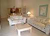 Living room with vaulted ceilings, queen size sofabed, cable TV/VCR, stereo and sliding doors to the balcony.