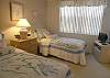 Guest bedroom with twin beds & flatscreen TV/VCR.