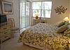 Master bedroom with king size bed, TV/DVD, walk-in closet, adjoining bath with large tub/shower & bay views from the window & sliding glass door to the balcony.