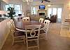 Dining table for six and two matching barstools at the kitchen pass-thru.