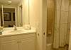 Guest bath with tub/shower and separate vanity area.