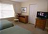 32" Flatscreen LCD TV & adjoining bath with oversized walk-in tile shower.