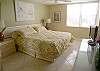 Master bedroom with new king size bed, flatscreen TV, walk-in closet & sliding doors onto the bayfront balcony.