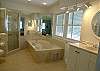 The spacious master bath has this large whirlpool  tub and a tile shower.