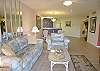 Living area with queen sized sofa bed &amp; matching side chair.