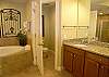 Large whirlpool tub, tile shower and double vanities.