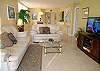 Living room with comfortable leather sofa & loveseat and 37 inch HDTV & DVD player.