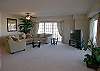 Liarge living room with big screen TV/DVD and sliding doors to the balcony.
