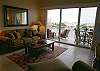 Living room with new queen size sofa bed and wide balcony with bay views.