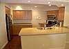 Kitchen with new flooring, cabinetry & solid surface counters with undermount sinks!