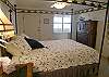 Furnished with a queen sized canopy bed, the third bedroom has an exterior door on the bay side.