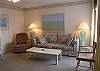 Living area with double sofa bed & comfortable recliner.