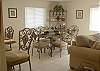 Large dining table has seating for six and there are also bar stools at the counter for more casual meals.